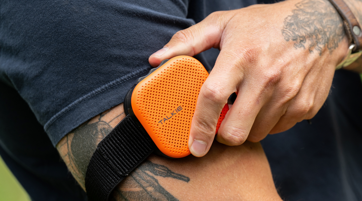 Orange TALKIE secured to the included armband holder