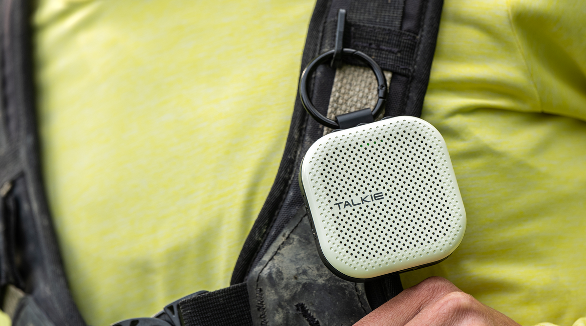 Ivory TALKIE clipped to a backpack strap using a carabiner